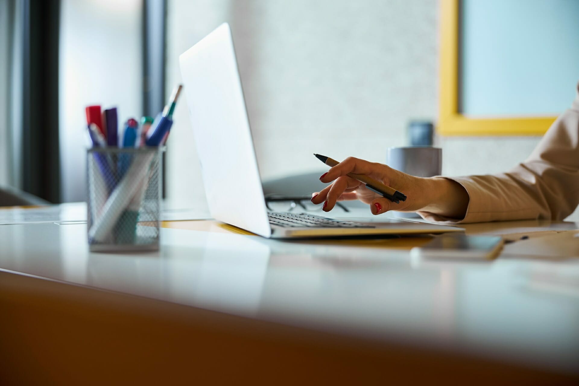 Competent worker sitting at her workplace while typing answer on email